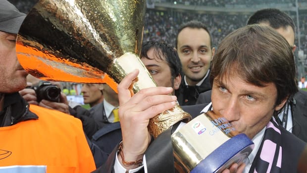 Manager Antonio Conte pictured kissing the trophy after leading Juventus to Serie A glory in the 2011/12 season