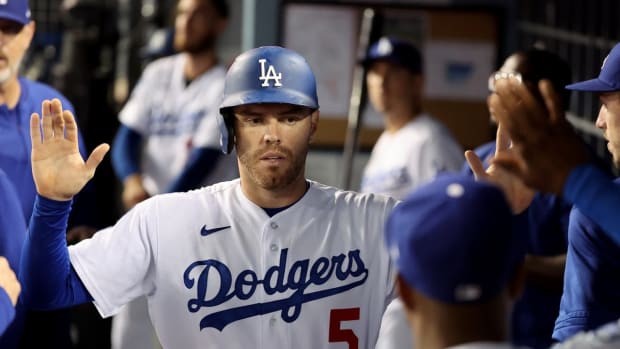 Sep 30, 2022; Los Angeles, California, USA; Los Angeles Dodgers first baseman Freddie Freeman (5) is greeted in the dugout after scoring a run during the fourth inning against the Colorado Rockies at Dodger Stadium. Mandatory Credit: Kiyoshi Mio-USA TODAY Sports