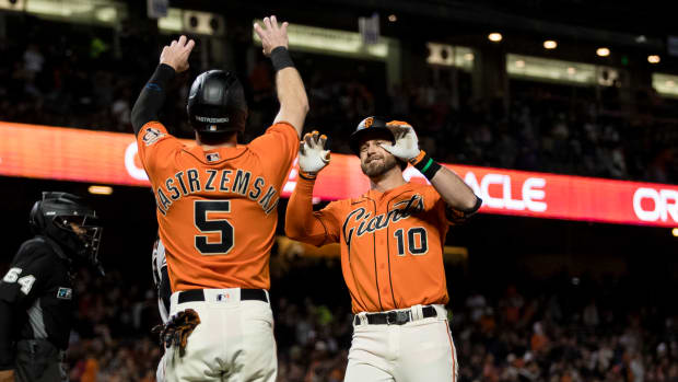 SF Giants sluggers Evan Longoria and Mike Yastrzemski celebrate at home plate after a home run by Longoria. (2022)