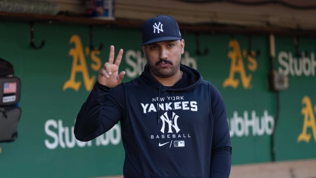 New York Yankees SP Nestor Cortes waves to fans in dugout