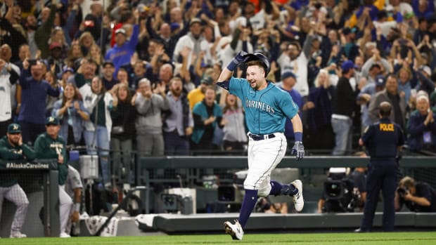 Mariners catcher Cal Raleigh celebrates hitting a walk-off home run against the Oakland Athletics to clinch a playoff berth.