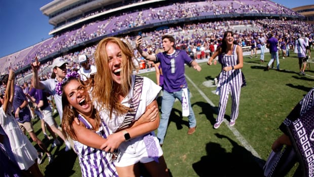 TCU fans run on to the field following the team's 55-24 win over Oklahoma in an NCAA college football game Saturday, Oct. 1, 2022, in Fort Worth, Texas. (AP Photo/Ron Jenkins)