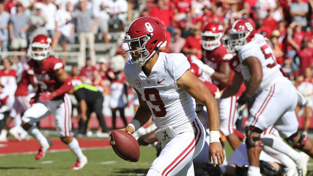 Oct 1, 2022; Fayetteville, Arkansas, USA; Alabama Crimson Tide quarterback Bryce Young (9) rushes for a touchdown in the first quarter against the Arkansas Razorbacks at Donald W. Reynolds Razorback Stadium.