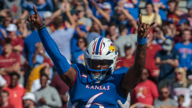 Kansas Jayhawks quarterback Jalon Daniels is lifted up by offensive lineman Dominick Puni (67) after a touchdown against the Iowa State Cyclones on Oct. 1, 2022.