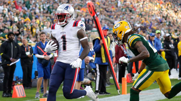 Oct 2, 2022; Green Bay, Wisconsin, USA; New England Patriots wide receiver DeVante Parker (1) scores a touchdown against Green Bay Packers cornerback Eric Stokes (21) during the second half at Lambeau Field.