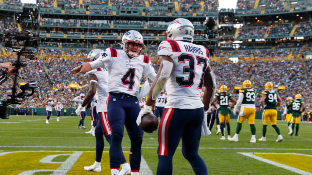 Oct 2, 2022; Green Bay, Wisconsin, USA; New England Patriots running back Damien Harris (37) celebrates with quarterback Bailey Zappe (4) after scoring a touchdown during the fourth quarter against the Green Bay Packers at Lambeau Field.