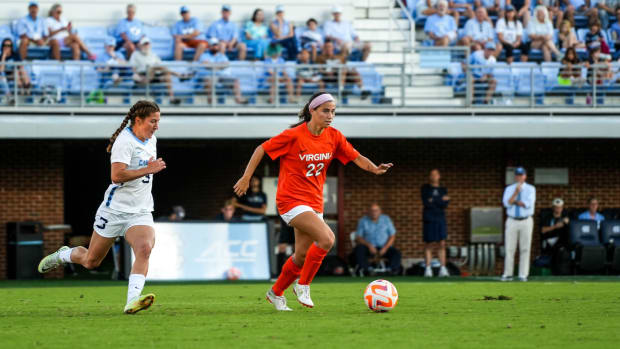 Junior midfielder Lia Godfrey dribbles the ball for the Virginia women's soccer team against North Carolina.