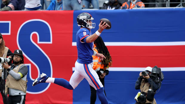 Oct 2, 2022; East Rutherford, New Jersey, USA; New York Giants quarterback Daniel Jones (8) runs for a touchdown against the Chicago Bears during the first quarter at MetLife Stadium.