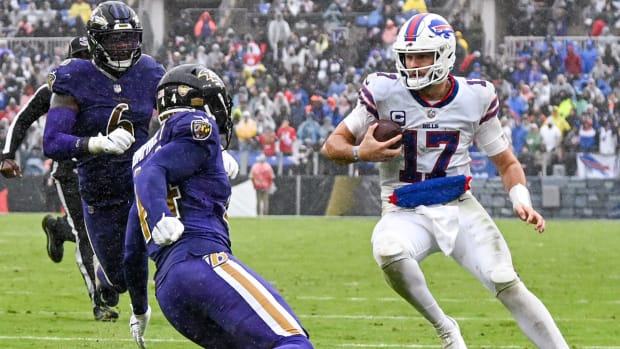 Josh Allen looks for a place to run in the rain against the Ravens.