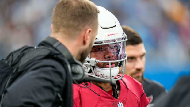 Cardinals quarterback Kyler Murray (1) speaks with coach Kliff Kingsbury during a game against the Panthers.