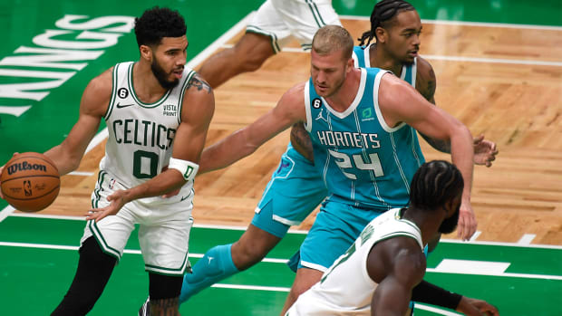 Oct 2, 2022; Boston, Massachusetts, USA; Boston Celtics forward Jayson Tatum (0) controls the ball while Charlotte Hornets center Mason Plumlee (24) defends during the first half at TD Garden.
