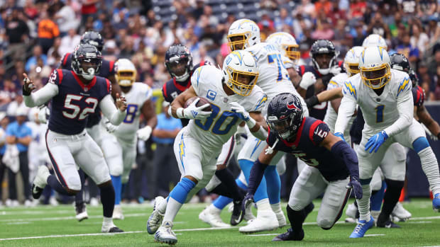Oct 2, 2022; Houston, Texas, USA; Los Angeles Chargers running back Austin Ekeler (30) scores a touchdown on a run as Houston Texans safety Jalen Pitre (5) attempts to make a tackle during the second quarter at NRG Stadium. Mandatory Credit: Troy Taormina-USA TODAY Sports