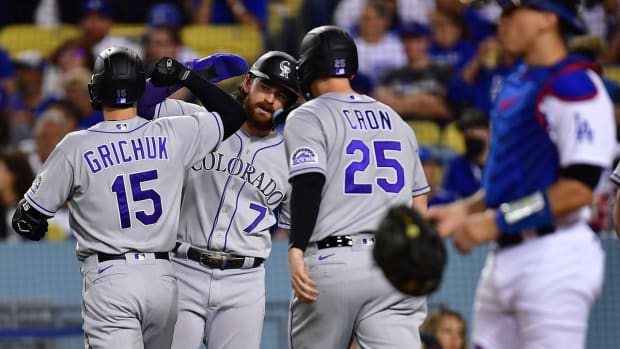 Oct 1, 2022; Los Angeles, California, USA; Colorado Rockies right fielder Randal Grichuk (15) is greeted by designated hitter Brendan Rodgers (7) and first baseman C.J. Cron (25) after hitting a three run home run against the Los Angeles Dodgers during the fourth inning at Dodger Stadium. Mandatory Credit: Gary A. Vasquez-USA TODAY Sports