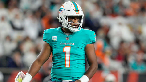 Miami Dolphins quarterback Tua Tagovailoa looks to the sidelines during the first half of an NFL football game against the Cincinnati Bengals.