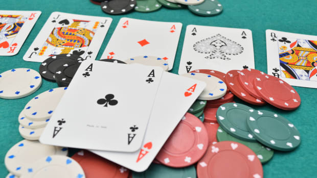 An aces pair on a gambling table with poker chips seen during a game of Texas Hold ‘Em.