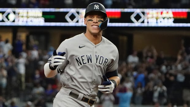 New York Yankees' Aaron Judge gestures as he rounds the bases after hitting his 62nd homer of the season