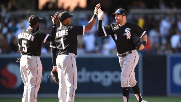 Oct 2, 2022; San Diego, California, USA; Chicago White Sox center fielder A.J. Pollock (18) celebrates with second baseman Elvis Andrus (1) and second baseman Josh Harrison (5) after defeating the San Diego Padres at Petco Park. Mandatory Credit: Orlando Ramirez-USA TODAY Sports