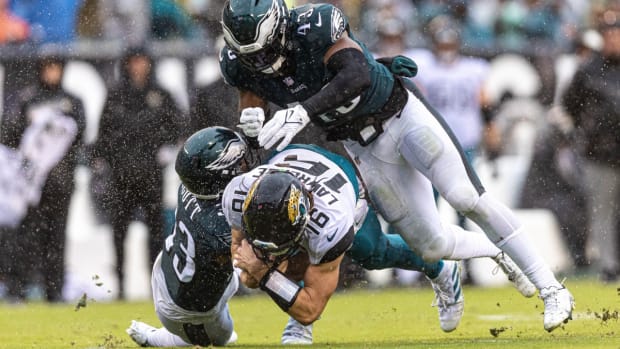 Josiah Scott (left) and Kyzir White make a tackle during Week 4's win over the Jaguars