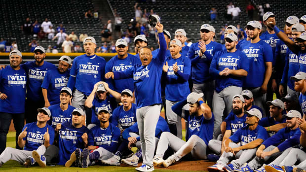 Sep 13, 2022; Phoenix, Arizona, USA; Los Angeles Dodgers manager Dave Roberts (30) salutes fans after clinching the National League West Division after defeating the Arizona Diamondbacks 4-0 at Chase Field.