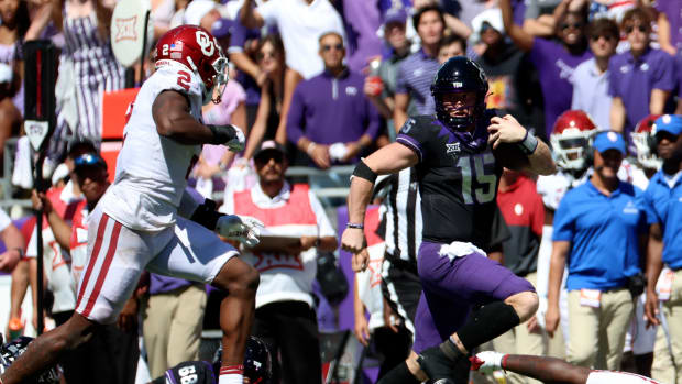 Oct 1, 2022; Fort Worth, Texas, USA; TCU Horned Frogs quarterback Max Duggan (15) runs with the ball as Oklahoma Sooners linebacker David Ugwoegbu (2) chases during the second half at Amon G. Carter Stadium.