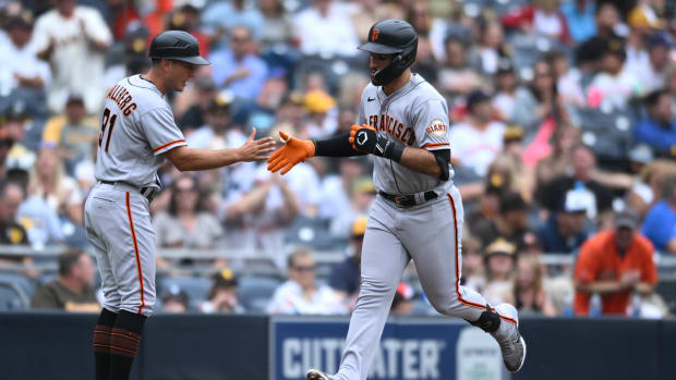 SF Giants infielder David Villar high fives Mark Hallberg after hitting a home run against the Padres on October 5th, 2022.