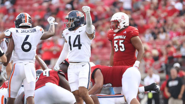Virginia Cavaliers defenders Nick Jackson and Antonio celebrate after making a defensive stop against the Louisville Cardinals.
