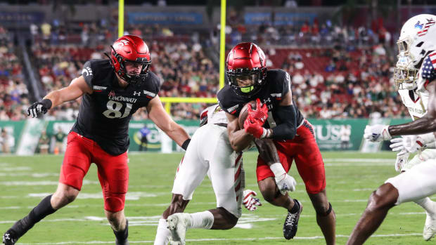 UC's Tre Tucker pushes through South Florida's defense to score a touchdown during the UC Bearcats and South Florida game at Raymond James Stadium on Friday November 12, 2021. UC lead the game at 24-7 by halftime.