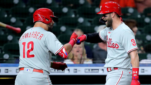 Oct 3, 2022; Houston, Texas, USA; Philadelphia Phillies left fielder Kyle Schwarber (12) celebrates with designated hitter Bryce Harper (3) after hitting a home run against the Houston Astros during the first inning at Minute Maid Park.