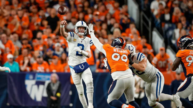 Oct 6, 2022; Denver, Colorado, USA; Indianapolis Colts quarterback Matt Ryan (2) passes under pressure from Denver Broncos defensive tackle DeShawn Williams (99) as offensive tackle Braden Smith (72) defends in the first quarter at Empower Field at Mile High. Mandatory Credit: Isaiah J. Downing-USA TODAY Sports