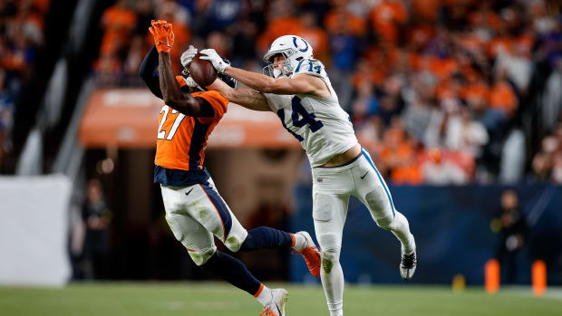 Oct 6, 2022; Denver, Colorado, USA; Indianapolis Colts wide receiver Alec Pierce (14) pulls in a pass under pressure from Denver Broncos cornerback Damarri Mathis (27) in the fourth quarter at Empower Field at Mile High. Mandatory Credit: Isaiah J. Downing-USA TODAY Sports