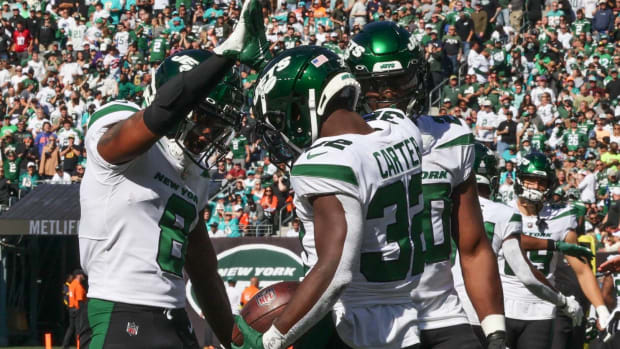 Jets running back Michael Carter and wide receiver Elijah Moore celebrate after Carter scored a touchdown vs. the Miami Dolphins.