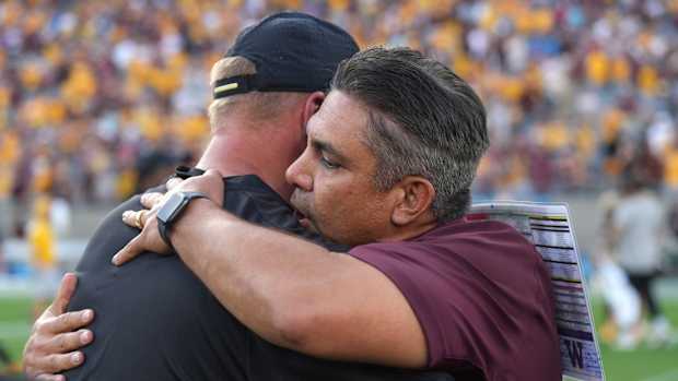 Kalen DeBoer and ASU interim coach Shaun Aguano embrace after Saturday's game.