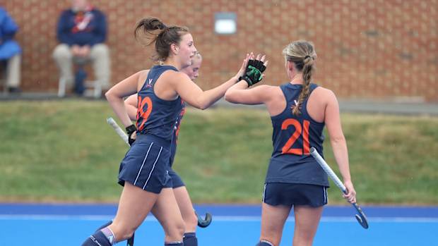 Dani Mendez-Trendler celebrates with her teammates after scoring a goal for the Virginia Cavaliers field hockey team.