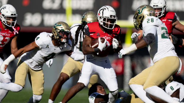 Cincinnati Bearcats running back Charles McClelland (10) runs downfield as South Florida Bulls safety Christian Williams (4) chases in the third quarter of the NCAA Football game between the Cincinnati Bearcats and the South Florida Bulls at Nippert Stadium in Cincinnati on Saturday, Oct. 8, 2022. South Florida Bulls At Cincinnati Bearcats 545