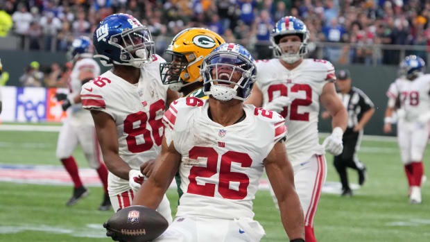 Oct 9, 2022; London, United Kingdom; New York Giants running back Saquon Barkley (26) celebrates after a run in the fourth quarter against the Green Bay Packers during an NFL International Series game at Tottenham Hotspur Stadium.