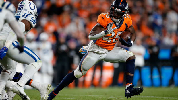 Denver Broncos running back Melvin Gordon III (25) runs the ball as Indianapolis Colts linebacker Bobby Okereke (58) defends in the third quarter at Empower Field at Mile High.