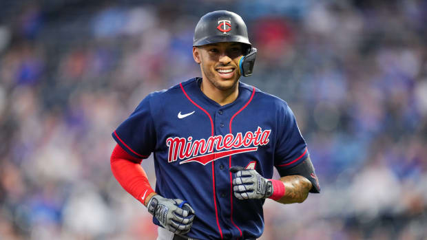 Twins shortstop Carlos Correa smiles as he jogs to the dugout. (2022)