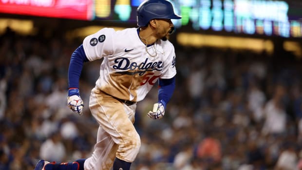 Oct 12, 2022; Los Angeles, California, USA; Los Angeles Dodgers right fielder Mookie Betts (50) hits a double in the seventh inning of game two of the NLDS for the 2022 MLB Playoffs against the San Diego Padres at Dodger Stadium.