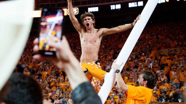 A fan cheer after climbing the downed goal past after Tennessee's game against Alabama in Neyland Stadium in Knoxville, Tenn., on Saturday, Oct. 15, 2022.