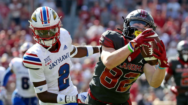 Oct 15, 2022; Norman, Oklahoma, USA; Oklahoma Sooners wide receiver Gavin Freeman (82) makes a diving catch past Kansas Jayhawks cornerback Cobee Bryant (2) during the first half at Gaylord Family-Oklahoma Memorial Stadium.