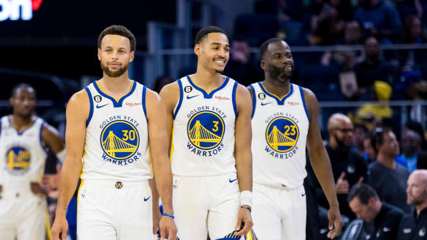 Oct 14, 2022; San Francisco, California, USA; Golden State Warriors guard Jordan Poole (3) and guard Stephen Curry (30) and forward Draymond Green (23) re-enter the court after a time-out during the first half of the game against the Denver Nuggets at Chase Center.