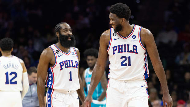 Oct 12, 2022; Philadelphia, Pennsylvania, USA; Philadelphia 76ers center Joel Embiid (21) talks with guard James Harden (1) after a score against the Charlotte Hornets during the first quarter at Wells Fargo Center.