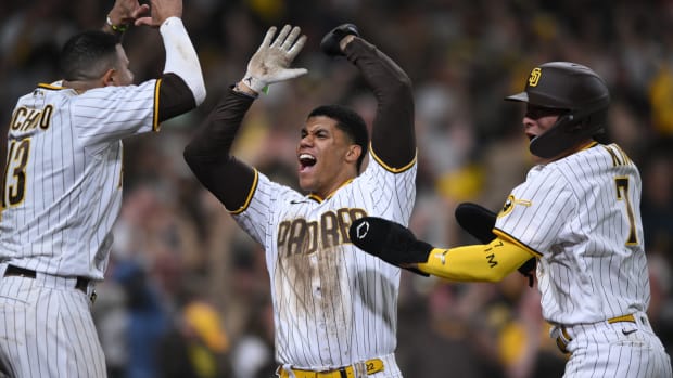 Padres star Juan Soto lifts his hands in the air in celebration