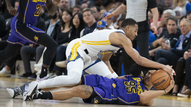 October 18, 2022; San Francisco, California, USA; Golden State Warriors guard Jordan Poole (3) and Los Angeles Lakers forward Juan Toscano-Anderson (95) fight for the ball during the third quarter at Chase Center. Mandatory Credit: Kyle Terada-USA TODAY Sports