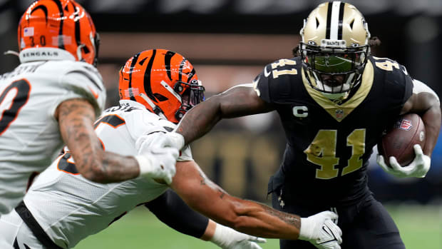 New Orleans Saints running back Alvin Kamara (41) carries the ball as Cincinnati Bengals linebacker Logan Wilson (55) tries to make a tackle in the second quarter during an NFL Week 6 game, Sunday, Oct. 16, 2022, at Mercedes-Benz Superdome in New Orleans.