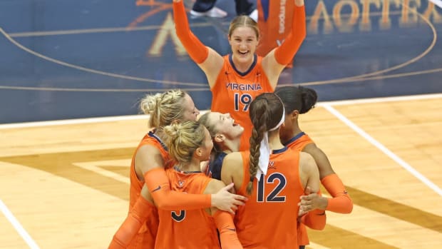 The Virginia volleyball team celebrates after scoring a point against Notre Dame at Memorial Gymnasium.