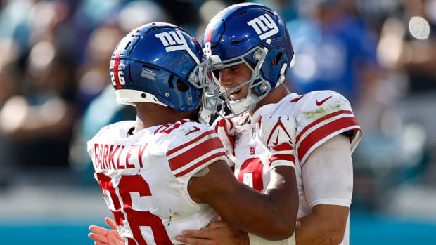 New York Giants quarterback Daniel Jones (8) celebrates with teammate running back Saquon Barkley (26) after scoring a touchdown against the Jacksonville Jaguars during the fourth quarter at TIAA Bank Field.