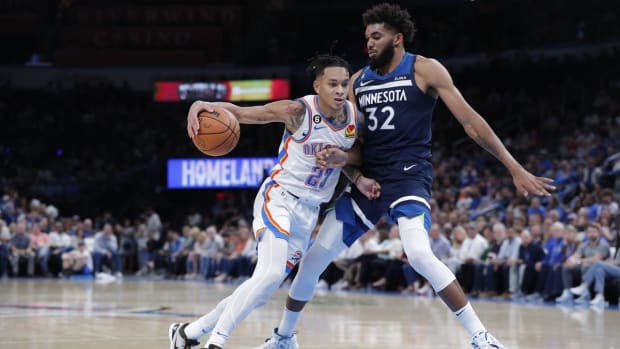 Oct 23, 2022; Oklahoma City, Oklahoma, USA; Oklahoma City Thunder guard Tre Mann (23) is defended by Minnesota Timberwolves center Karl-Anthony Towns (32) on a drive to the basket during the second half at Paycom Center. Minnesota won 116-106. Mandatory Credit: Alonzo Adams-USA TODAY Sports