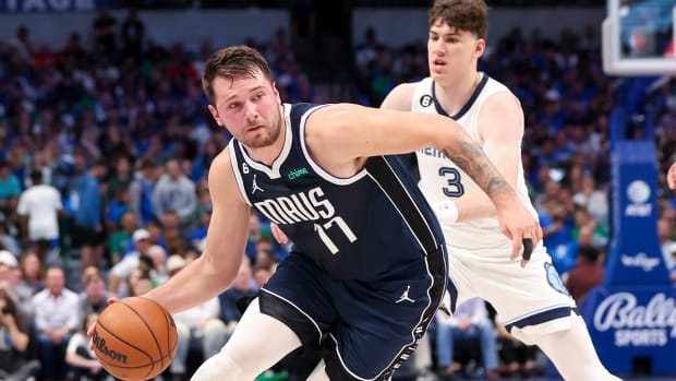Dallas Mavericks guard Luka Dončić (77) controls the ball as Memphis Grizzlies forward Jake LaRavia (3) defends during the first quarter at American Airlines Center.