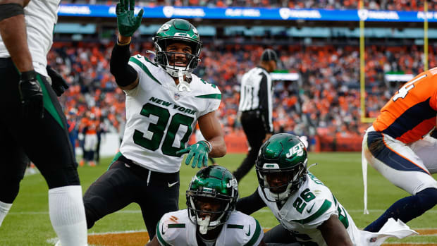 Oct 23, 2022; Denver, Colorado, USA; New York Jets cornerback Michael Carter II (30) and cornerback Brandin Echols (26) celebrate after a play from cornerback Sauce Gardner (1) in the fourth quarter against the Denver Broncos at Empower Field at Mile High.
